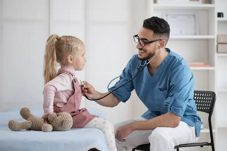 Pediatrician examining child